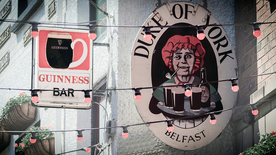 Beer signs hanging from buildings in Belfast, Northern Ireland